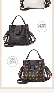 Detail view of coffee-colored bucket bags featuring vintage prints and metallic hardware