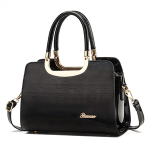 Glossy black commuter handbag with linear texture and golden metal handle hardware