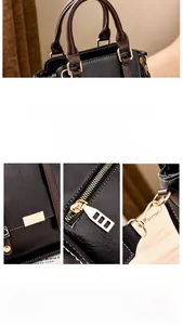 Detail shot of the gold-toned hardware and leather texture of this black handbag