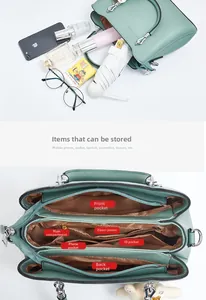 Detail of green PU leather handbag featuring multiple internal storage compartments