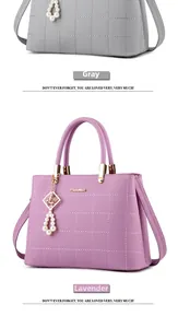 Detail of grey and purple quilted handbags with pearl charms and metal handle bases
