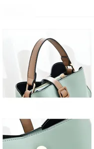 Détails du sac seau en similicuir vert menthe avec poignées marron et coutures
