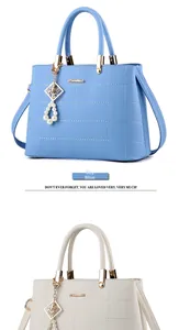 Close-up of sky blue and cream white PU leather bag with lattice stitching and pearl charm