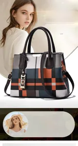 Detailed view of women's plaid tote bag with colorful pattern and brown leather straps