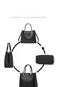 Detail view of black leather handbag with silver hardware and adjustable shoulder strap