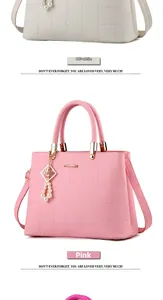 Close-up of quilted PU leather handbag details with pearl pendant in beige and pink