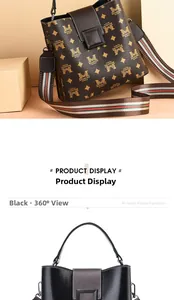 Detail view of stylish leather handbag with monogram pattern and metallic clasp detail