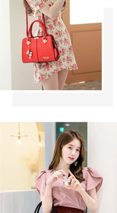 Detail of red crocodile texture handbag featuring metal clasp and tassel charm in a lifestyle shot