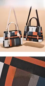 Close-up of color-block plaid fabric texture and details of the large tote handbag