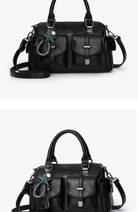 Close-up detail of a stylish black soft leather handbag featuring double front pockets.
