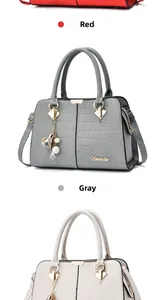 Detail view of crocodile embossed leather handbags in red, gray and beige colors