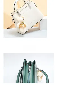 Close-up of soft leather handbag with multi-layer interior and plush bear charm
