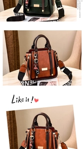 Detail of vintage PU leather handbag with wide logo strap and bear charm accessory