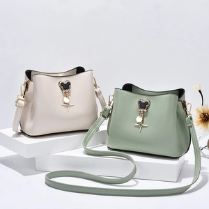 Minimalist PU leather bucket bag with mouse shaped metal buckle in beige and green