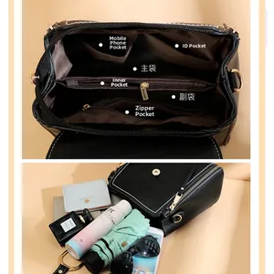 Detailed interior of black leather handbag showing multi-pocket storage and large capacity