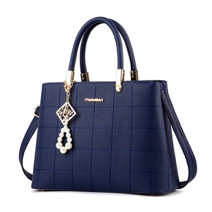 Dark blue lattice embroidered handbag with gold hardware and luxury pearl charm detail