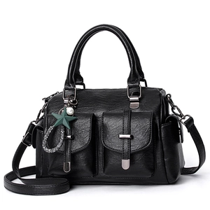 Elegant black soft leather handbag featuring dual front pockets and a chic star charm