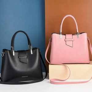 Modern PU leather handbags in black and pink with metal buckle and shoulder straps