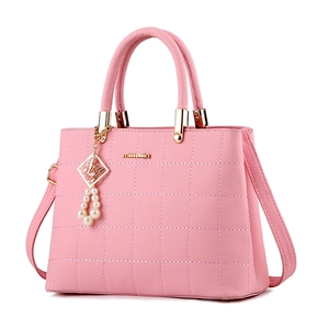 Pink quilted crossbody handbag for women with gold hardware and pearl charm decoration