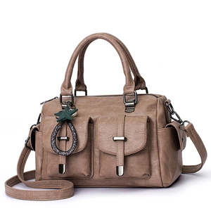 Stylish brown soft leather handbag featuring dual front pockets and unique star charm.