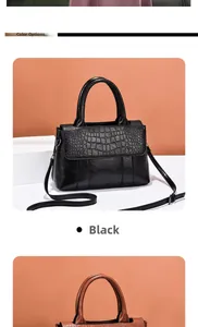 Detail view of black handbag featuring smooth leather and embossed crocodile texture