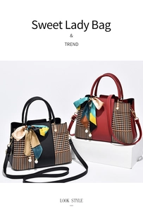 Detail of elegant two-tone handbags with houndstooth stitching and decorative silk scarf