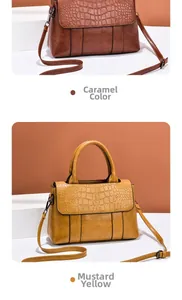 Detail view of caramel and ginger yellow handbags with faux crocodile leather texture