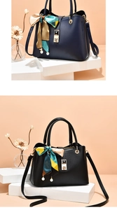 Detailed view of pebble leather handbags with decorative silk scarves and pearl charms