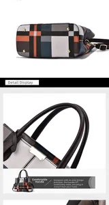 Detail of color-block plaid handbag base with gold studs and comfortable brown handles