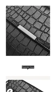 Detail of black crocodile texture bag with white stitching and magnetic closure