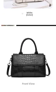 Detail of black faux leather handbag showing textured croc-effect flap and smooth finish