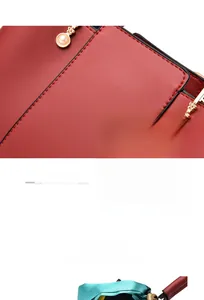 Close-up of wine red leather texture and plaid fabric stitching on large handbag