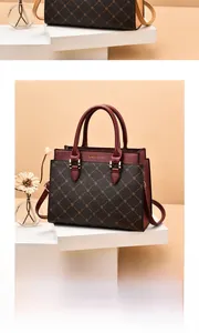 Close-up of wine red and coffee brown patchwork handbag with floral patterns and gold hardware