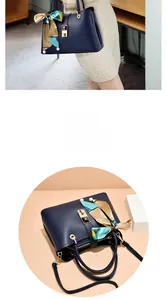 Detail of dark blue faux leather handbag with silk scarf and pearl pendant accents