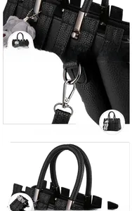 Detail van zwarte handtas met litchi-patroon, geweven ontwerp en metalen hardware