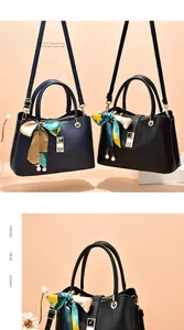 Detail of lychee pattern leather handbag with silk scarf handle and pearl pendant