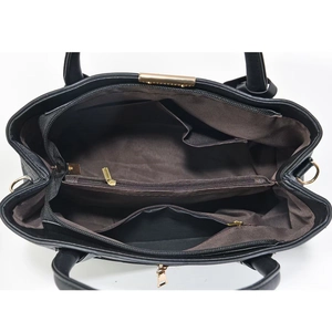 Interior view of black leather tote bag with multi-layer pockets and gold zipper detailing