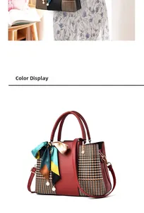 Detail view of red leather and houndstooth patchwork handbag with decorative silk scarf
