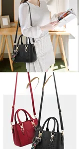 Close-up of quilted handbag texture with pom-pom charm and golden hardware detail