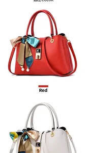 Detail view of red and beige textured faux leather handbags with gold clasps and silk scarves