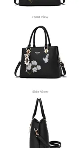 Detail of black embroidered handbag with floral butterfly patterns and tassel charm