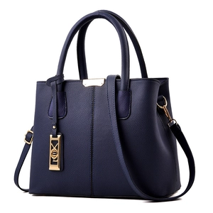 Deep blue lychee textured leather tote bag with gold hardware and top handles