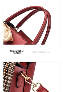Detail of red leather handbag handles and golden metal lobster clasps for shoulder straps