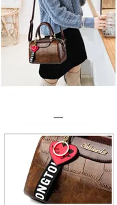 Detail of retro crocodile texture pillow bag featuring heart and ribbon charms