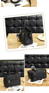 Detailed views of black pebbled leather handbag with pompom and gold hardware
