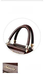 Detailed macro view of dark brown stone pattern leather handle and golden metal logo