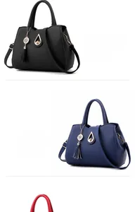 Detail of lychee textured leather handbags with gold teardrop twist locks and stylish tassels