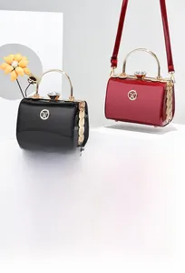 Detailed close-up of glossy patent leather handbags with elegant gold metal hardware