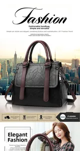 Close-up of black litchi pattern PU leather handbag with contrasting wine red handle