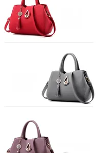 Detailed close-up of textured leather handbags featuring metal tassel and drop-shaped lock